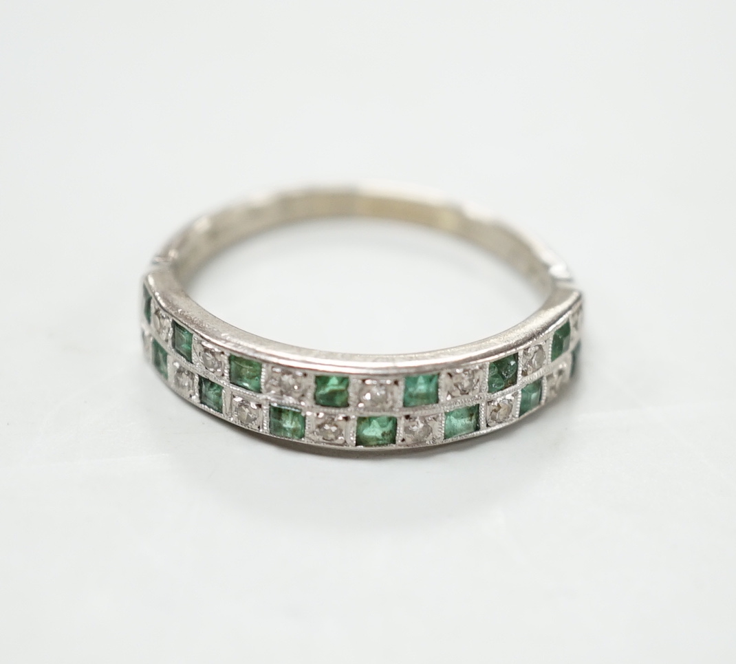 A modern 18ct white gold and two row emerald and diamond cluster set half hoop ring, size S, gross weight 4.5 grams.